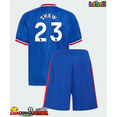 Camisa de Futebol Manchester United Luke Shaw #23 Equipamento Secundário Infantil 2026-27 Manga Curta (+ Calças curtas)